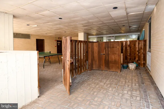 a view of a hallway with wooden shelves