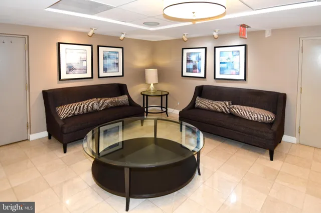 a living room with furniture a table and a large window