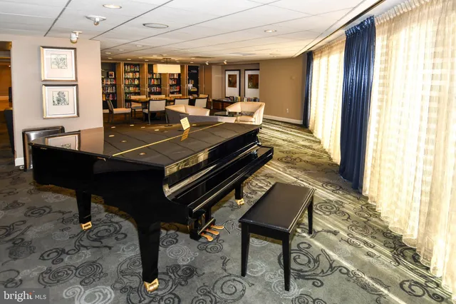 a kitchen with stainless steel appliances kitchen island granite countertop a table chairs in it and wooden floors