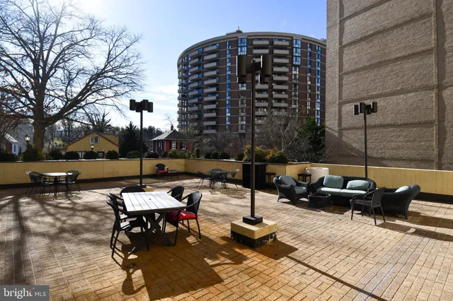 a living room with couches a dining table and chairs with kitchen view