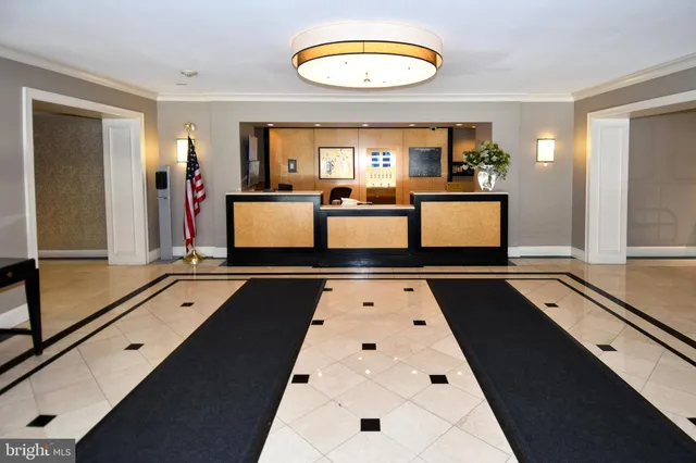a living room with a couch and a chandelier