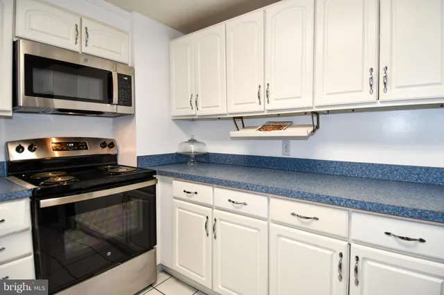 a kitchen with stainless steel appliances granite countertop a stove a microwave and cabinets