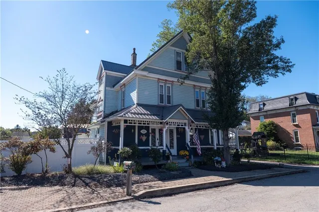 a front view of a house with garden