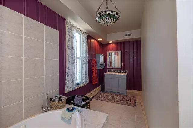 a view of a bathroom with a bathtub and shower