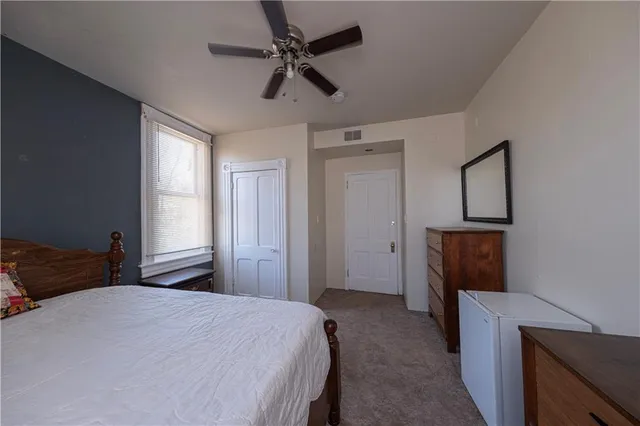 a bedroom with a bed and a television