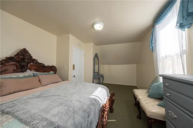 a bedroom with two beds and a window