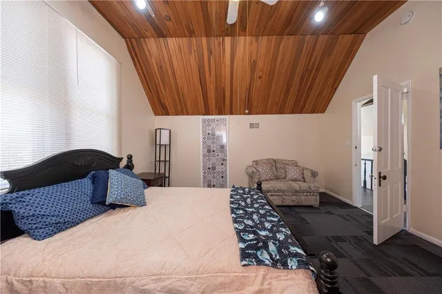 a bedroom with a bed rug and wall painting