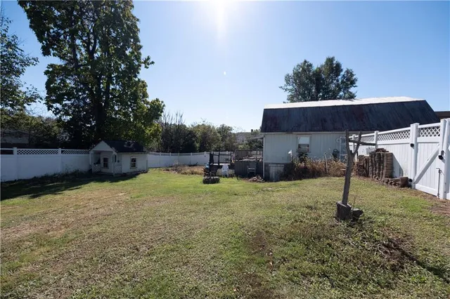 a backyard of house with a slide and swing
