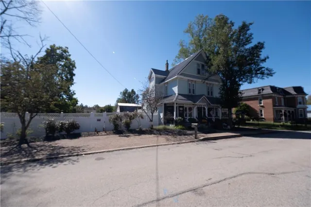 a yellow house with trees in front of it