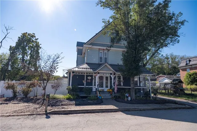 a front view of a house with a garden