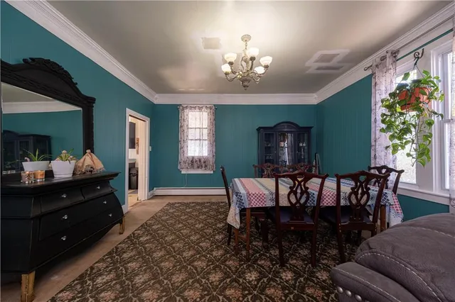 a view of a dining room with furniture and a chandelier