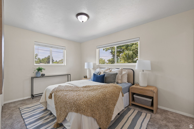 2370 Quail Run Circle East Sandy, UT 84093 - Photo 13 of 54 Carpeted room featuring two windows with white blinds, a flush-mount ceiling light, and light-toned wall paint