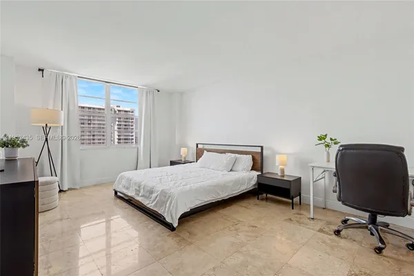 a living room with a bed furniture and a window