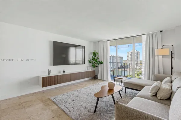 a living room with furniture and a flat screen tv