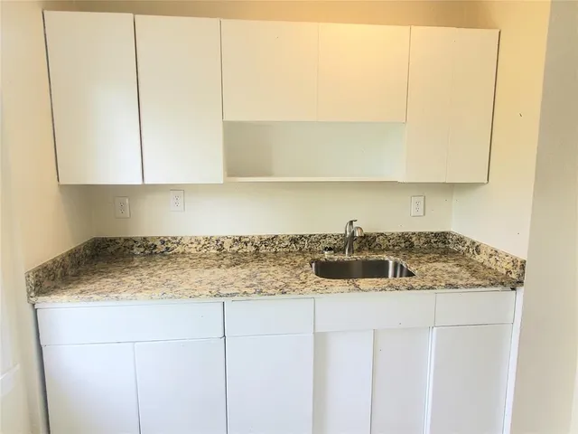 a kitchen with a sink and cabinets