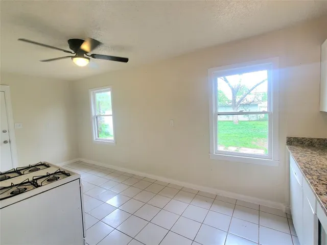 a kitchen that has a stove a sink and a window