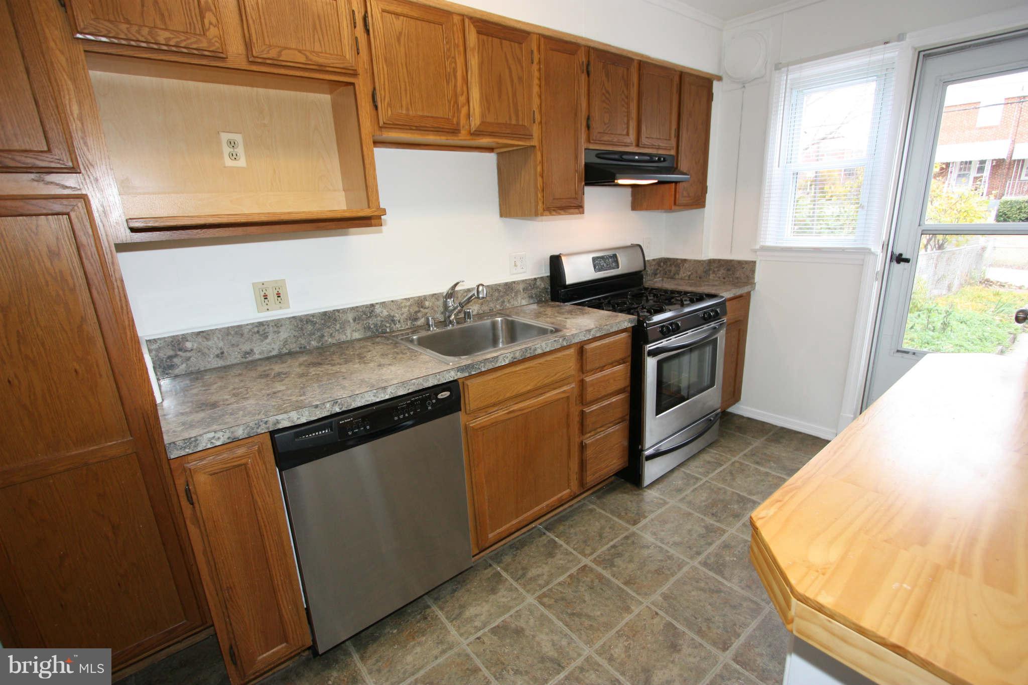1606 Aberdeen Road Towson, MD 21286 - Photo 3 of 30 a kitchen with stainless steel appliances granite countertop a stove a sink and a microwave