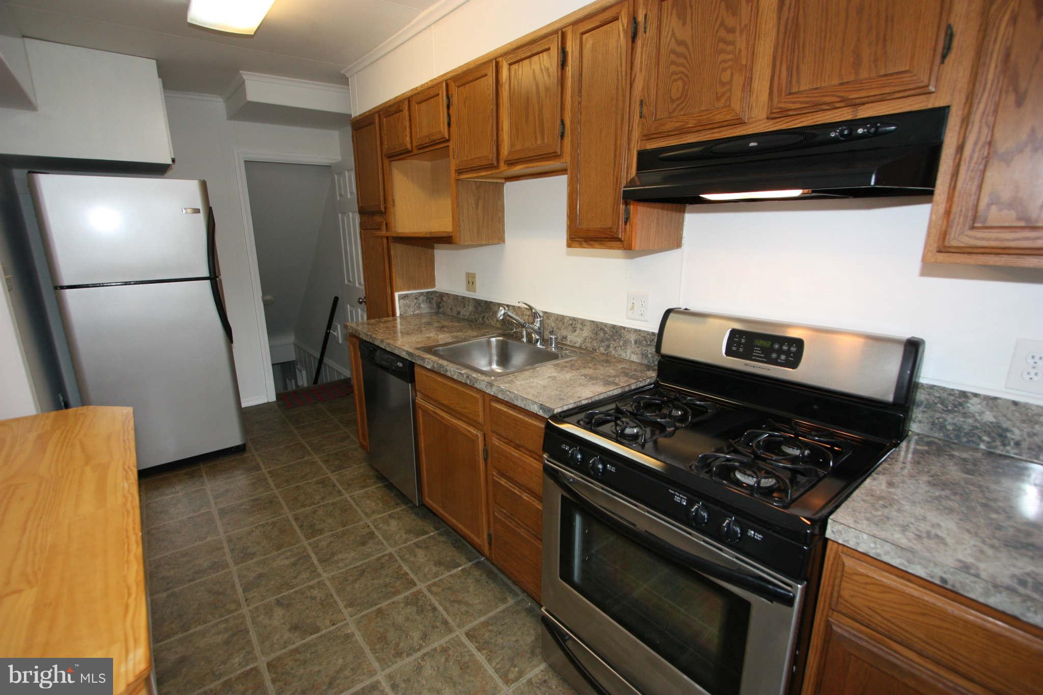 1606 Aberdeen Road Towson, MD 21286 - Photo 5 of 30 a kitchen with granite countertop a stove and a refrigerator