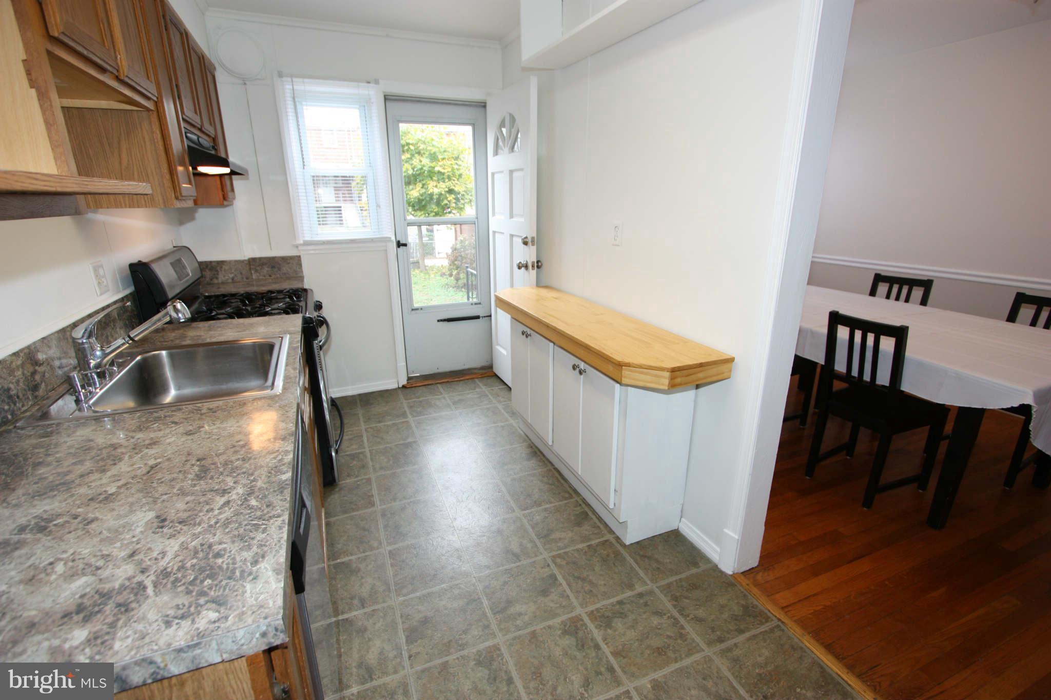 1606 Aberdeen Road Towson, MD 21286 - Photo 7 of 30 a kitchen with granite countertop a stove a sink and a refrigerator