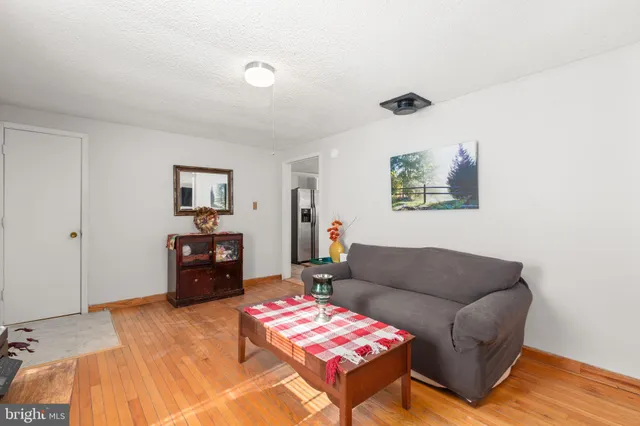 a living room with furniture or couch and a chandelier