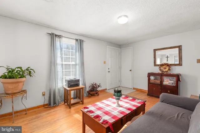 a living room with furniture a chandelier and a window