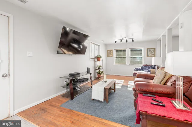 a view of a kitchen area with cabinets and wooden floor