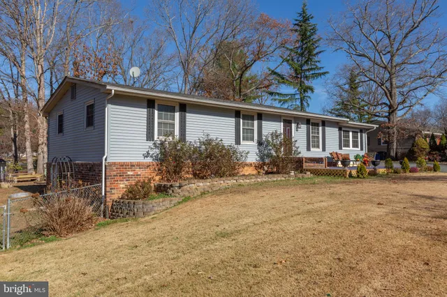 a backyard of a house with garden and outdoor seating