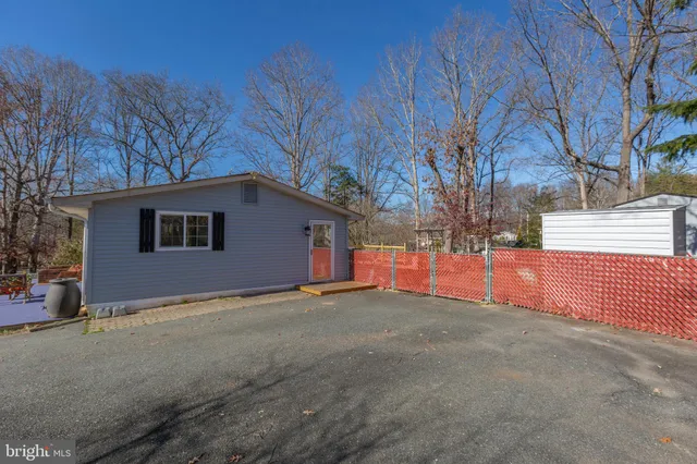 a view of empty room with tree and wooden fence
