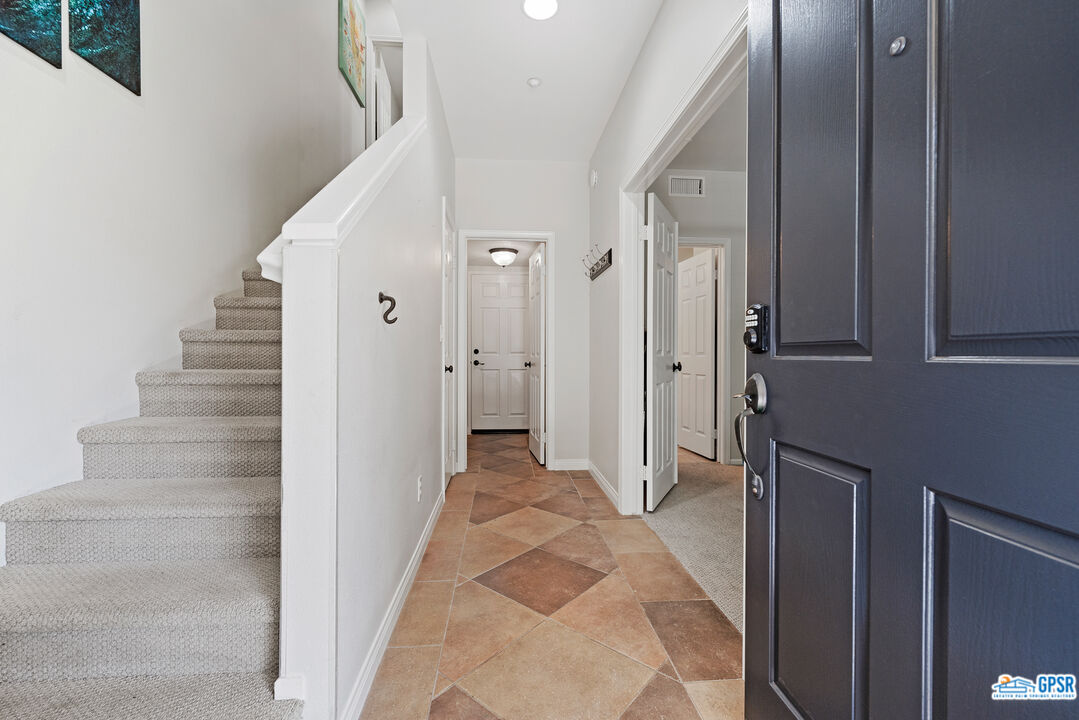 22 Paseo Rosa San Clemente, CA 92673 - Photo 2 of 24 a view of a hallway with white walls and door