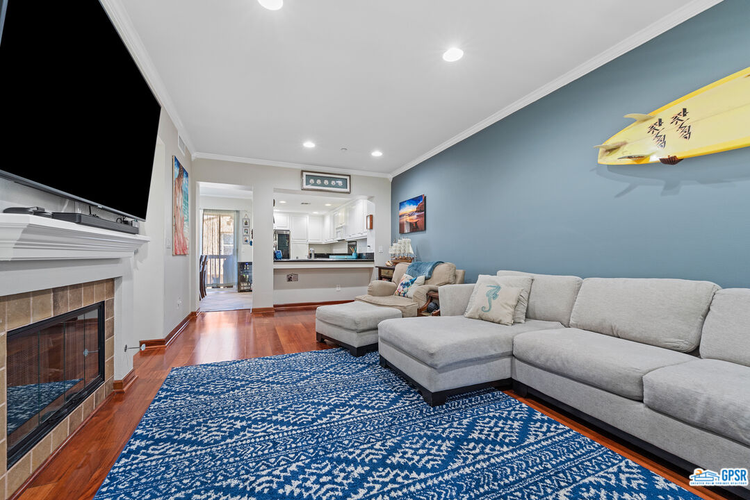 22 Paseo Rosa San Clemente, CA 92673 - Photo 9 of 24 a living room with furniture a fireplace and a flat screen tv