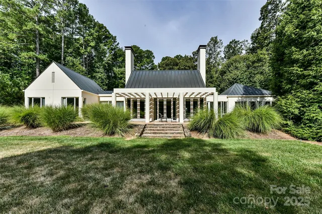 a view of a house with a yard and sitting area