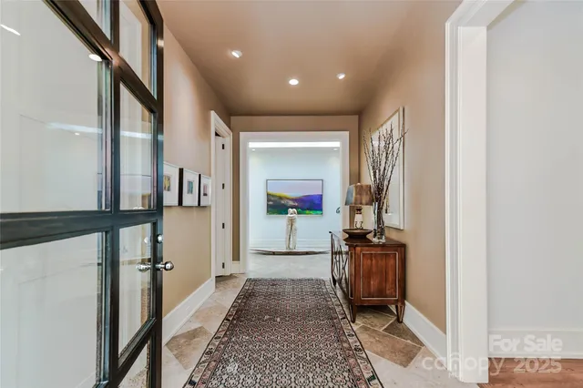 a hallway with a view of living room