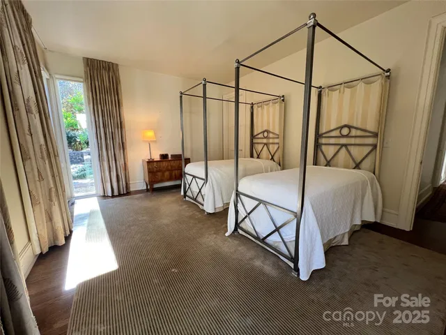 a bedroom with a bed a couch and a dresser