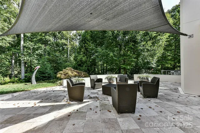 a view of a patio with table and chairs and potted plants