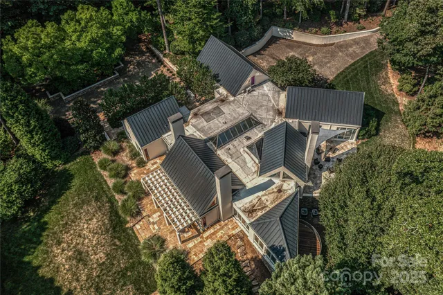 an aerial view of a house with a yard and trees