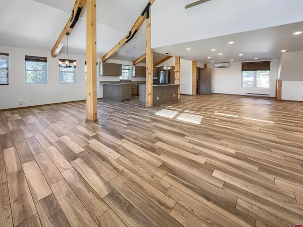 a view of a living room with kitchen and furniture