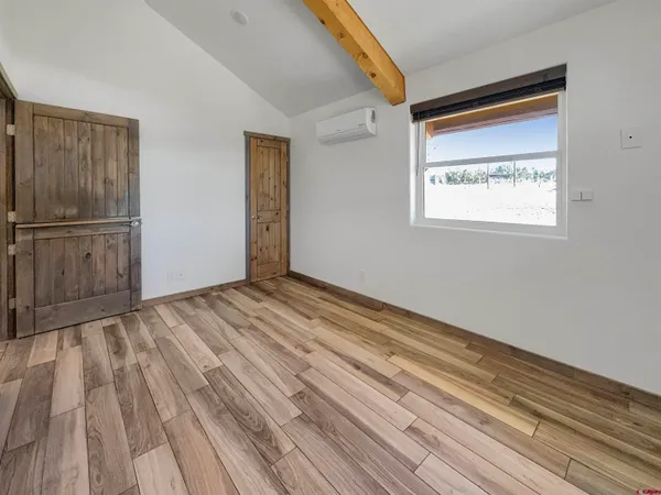 a view of a room with wooden floor and cabinet
