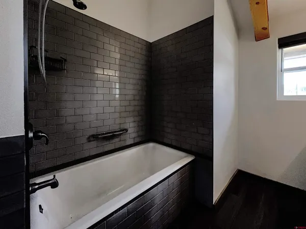 a bathroom with a bathtub and shower