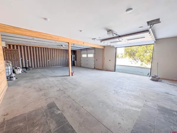 a view of a livingroom with wooden floor and a ceiling fan