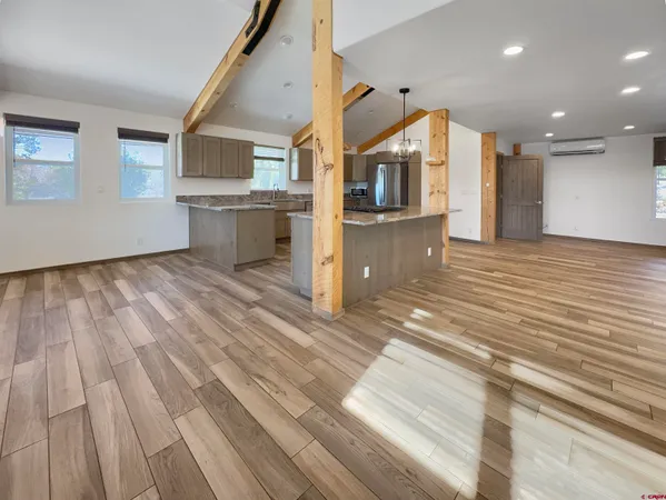 a view of a kitchen with wooden floor and a kitchen