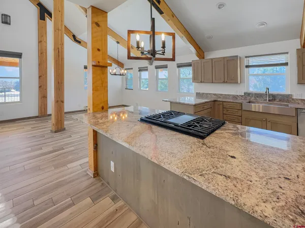 a kitchen with stainless steel appliances granite countertop a stove and a wooden floors