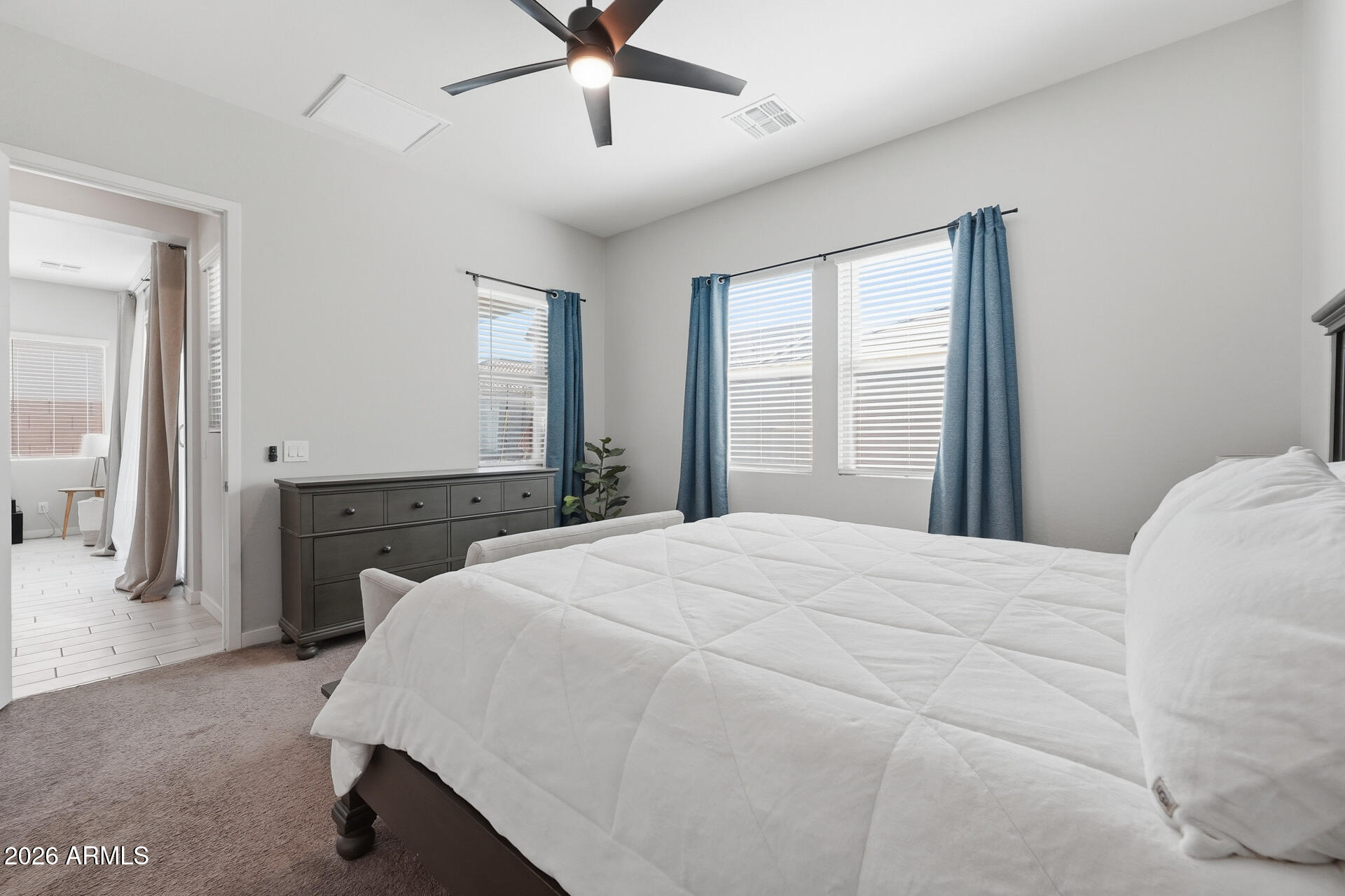 23069 East Mayberry Road Queen Creek, AZ 85142 - Photo 18 of 48 a bedroom with a large bed and a chandelier