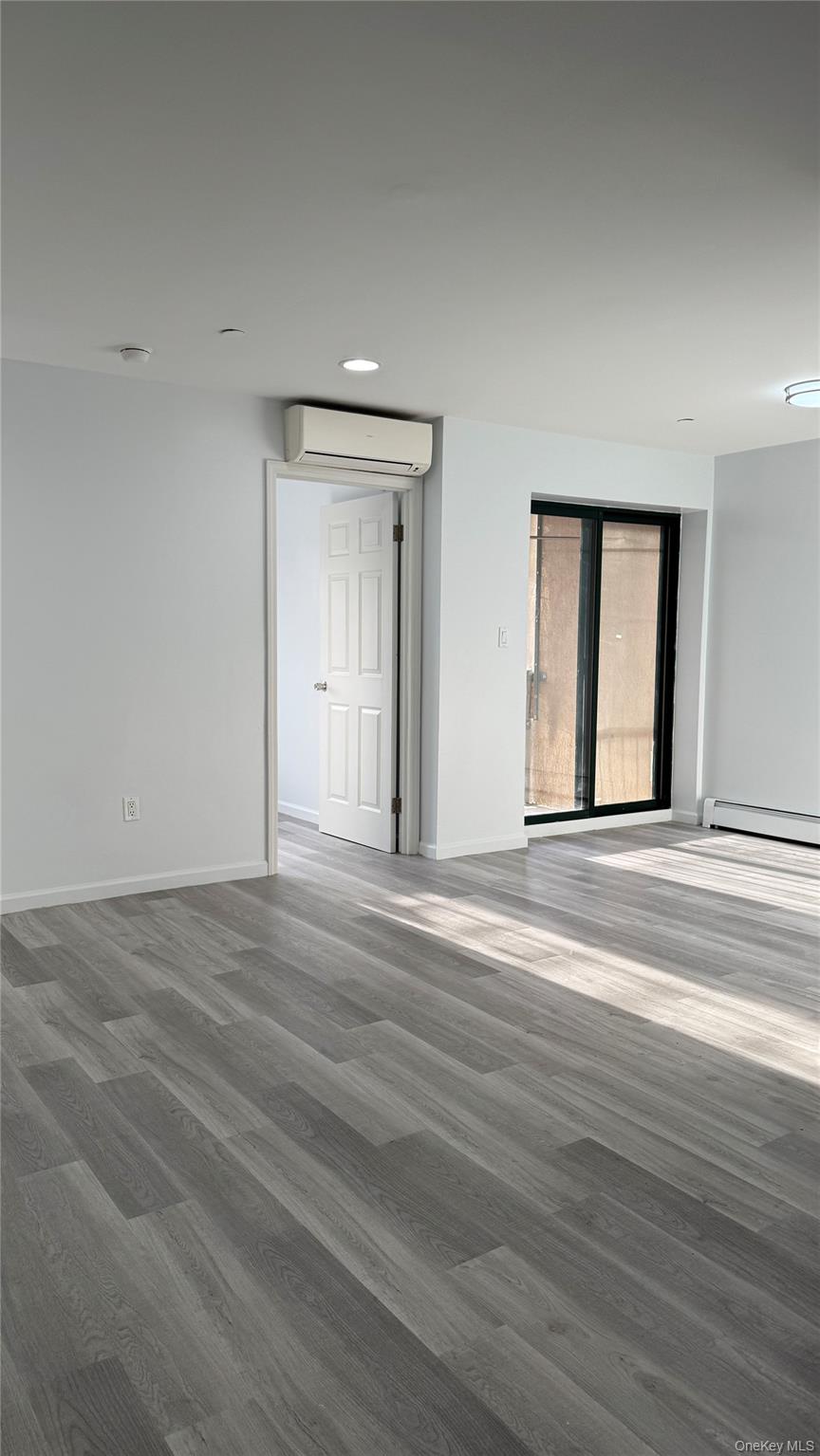 43-20 Union Street, Unit 6D Queens, NY 11355 - Photo 4 of 8 a view of empty room with wooden floor and fan