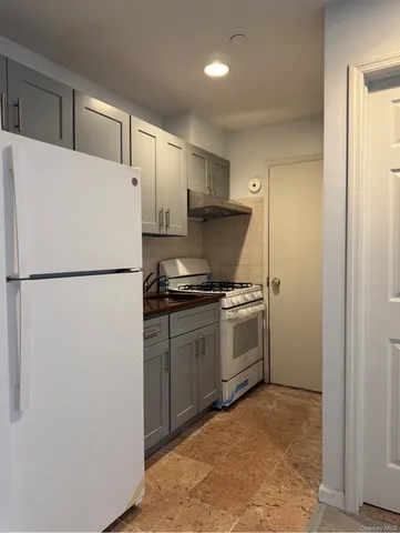 a kitchen with a refrigerator and a stove