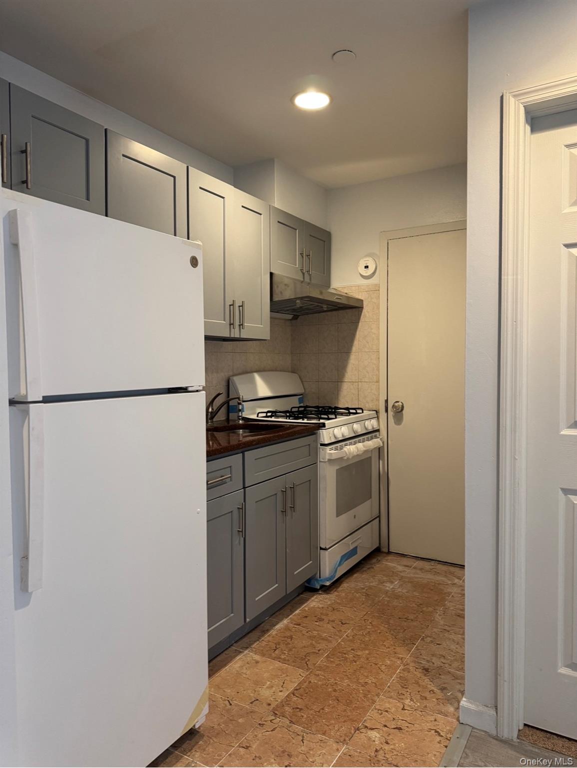 43-20 Union Street, Unit 6D Queens, NY 11355 - Photo 5 of 8 a kitchen with a refrigerator and a stove