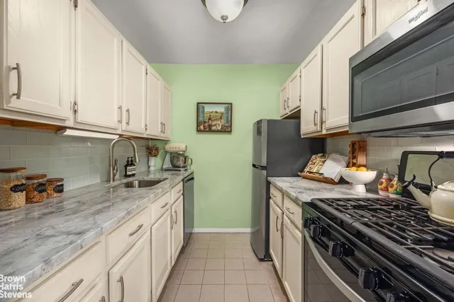 a kitchen with stainless steel appliances granite countertop a stove and a sink