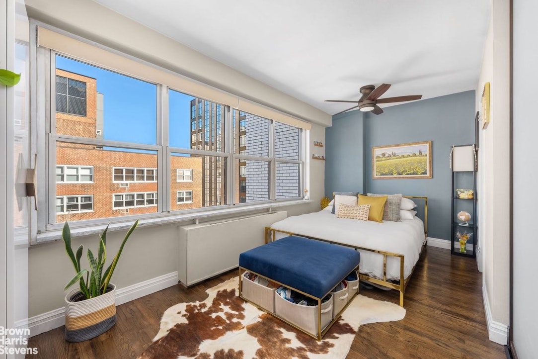 205 3rd Avenue, Unit 17L Manhattan, NY 10003 - Photo 5 of 10 a living room with furniture a rug and a window