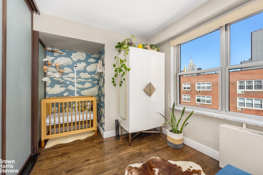 205 3rd Avenue, Unit 17L Manhattan, NY 10003 - Photo 6 of 10 a living room with a couch and a window