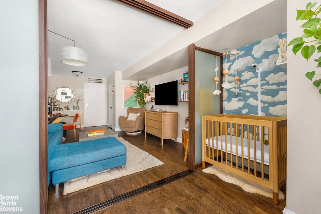 205 3rd Avenue, Unit 17L Manhattan, NY 10003 - Photo 7 of 10 a living room with furniture and a flat screen tv