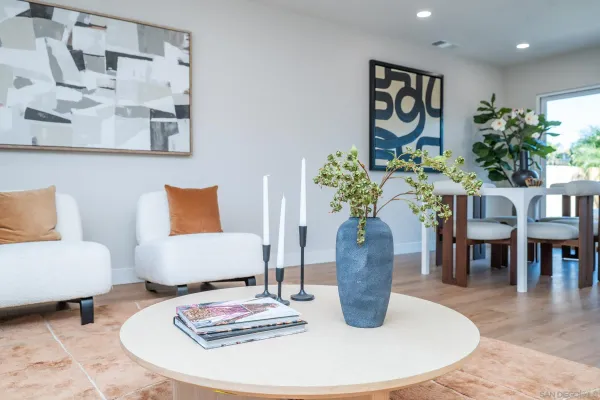a kitchen with a dining table chairs and refrigerator